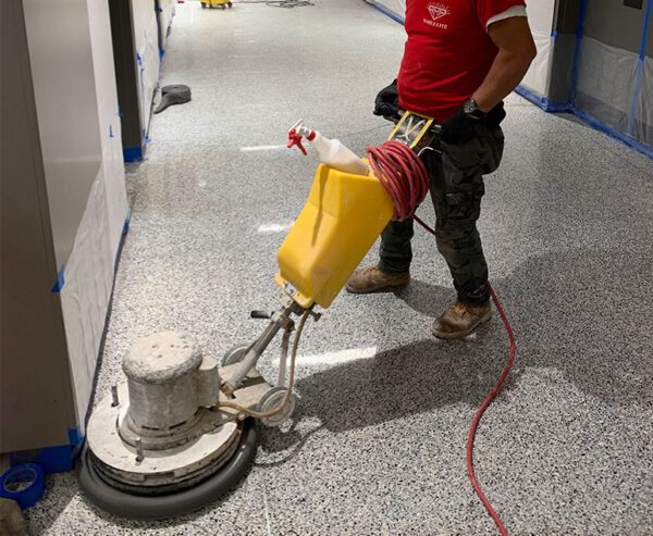 services-homeArtboard-1-600x493 a man is carring maintenance on hose floor with cleaning machine